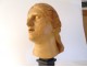 Head sculpture of a young woman in natural wood carved at the end of the 19th century