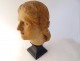 Head sculpture of a young woman in natural wood carved at the end of the 19th century