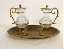 Pair of cruets with gilded metal trays and engraved crystal glass cabochon, 19th century