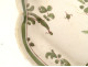 Oval earthenware dish from Moustiers with a figure, flowers, and foliage, 18th century