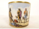 Porcelain cup and saucer depicting a Parisian scene with figures, gentleman, and dog, 19th century