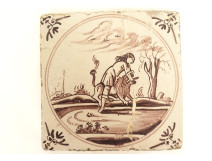 Delftware manganese tile depicting a biblical scene of Samson and the lion, 18th century