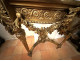 Louis XVI half-moon console table in gilt wood with coat of arms, heraldic shield, flowers, and marble, 19th century