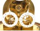 Skeleton clock and alarm unit fractions, under glass, in gilt brass nineteenth