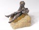 silvered bronze sculpture child sledding stone twentieth century